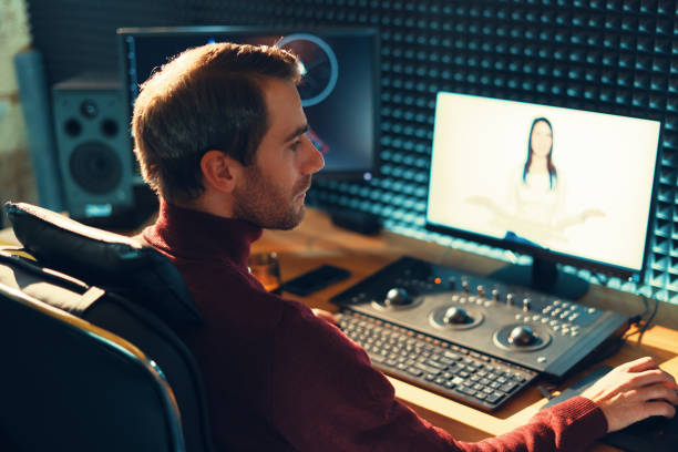 istock Male Videographer Edits and Cuts Footage and Sound on His Personal Computer 1160999838