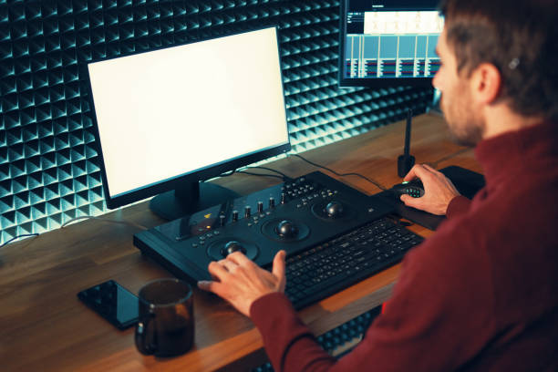 istock Male Videographer Edits and Cuts Footage and Sound on His Personal Computer 1160999841