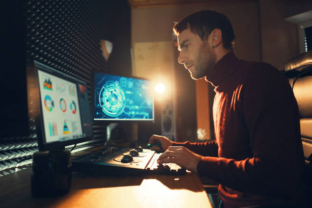 istock Male Videographer Edits and Cuts Footage and Sound on His Personal Computer 1160999868