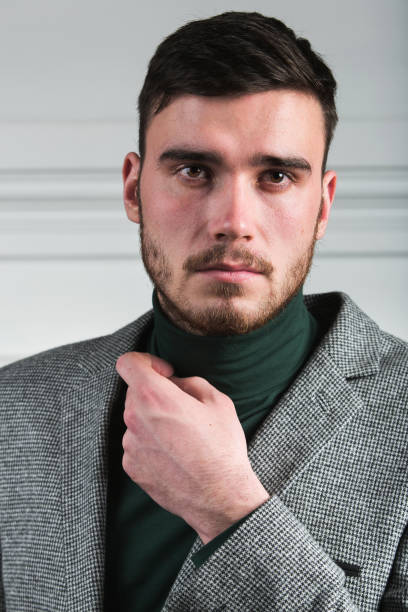 istock Handsome stylish young man standing in interior on white background 1161000777