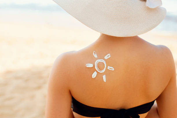 istock Woman With Suntan Lotion Shaped Sun 1161001013
