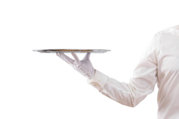 istock Waiter holding empty silver tray isolated on white background 1161003800