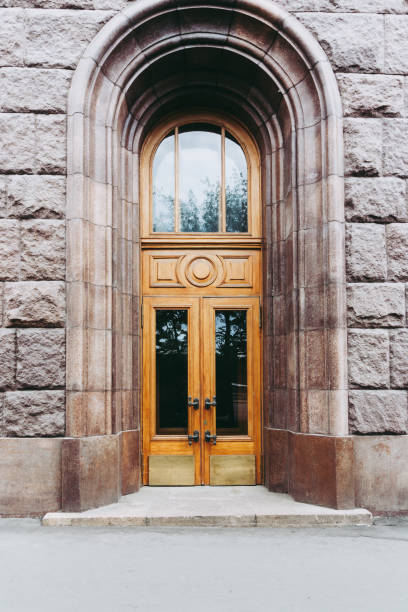 amazing wooden doors and transom with massive bronze handles in art deco style