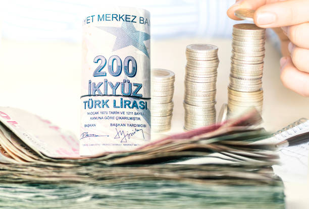 stacked turkish lira banknotes and coins - tl imagens e fotografias de stock