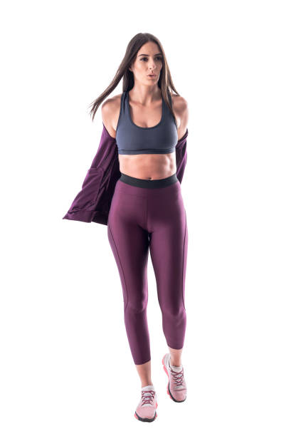 istock Determinate young athletic woman removing tracksuit jacket getting ready for exercise. 1161006465