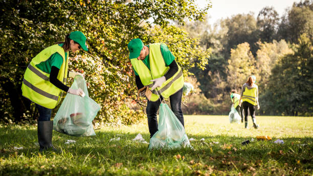 istock Volunteers in reflective vests cleaning garbage in a park 1161008261