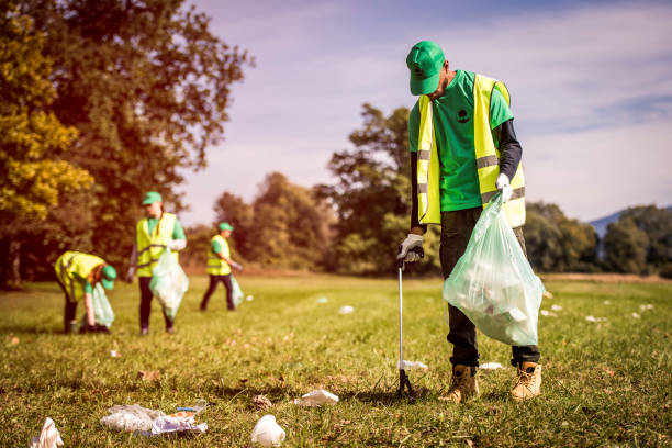 istock Volunteers picking up trash in a park 1161008273