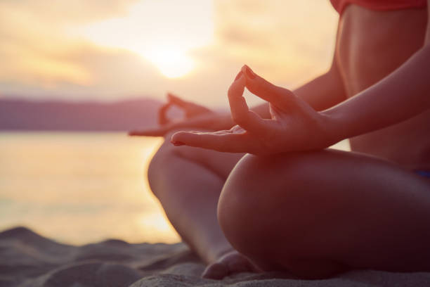 istock Young woman practicing yoga on the sandy beach. 1161009199