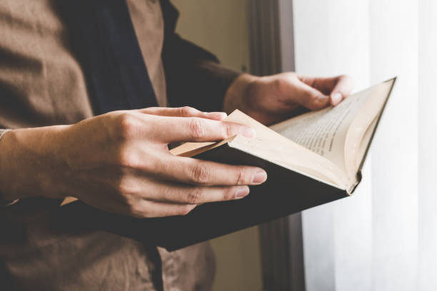 istock Businessman holding book at window. Creative Business Startup Idea. 1161009812