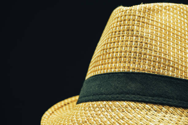 istock Close up Straw hat on a black glass table background. 1161011037