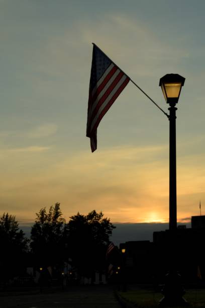 istock American Flag Against Cloudy Sunrise 1161014930