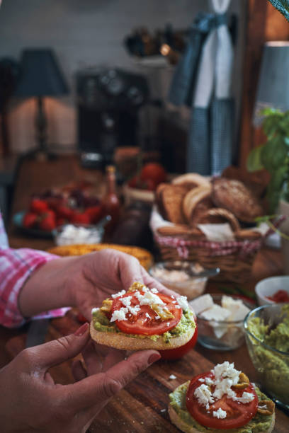 istock Preparing Avocado Sandwich with Tomato and Feta Cheese 1161016653