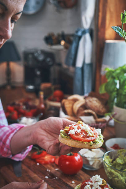 istock Preparing Avocado Sandwich with Tomato and Feta Cheese 1161016657
