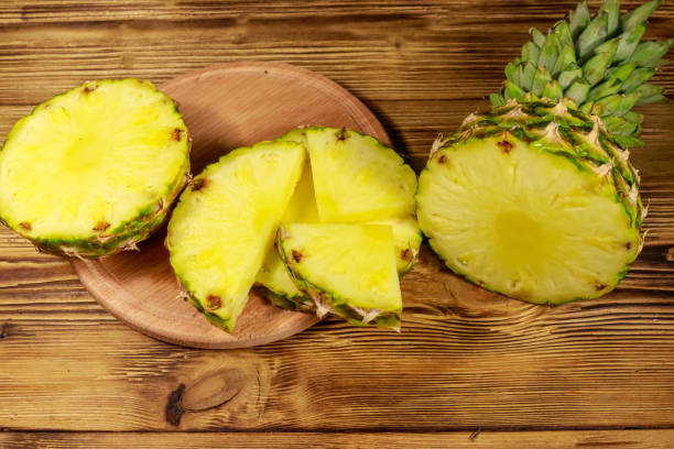 istock Fresh pineapple on wooden table 1161017815