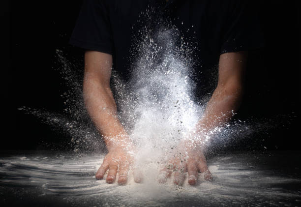 istock hand clap and white flour on black background 1161018231