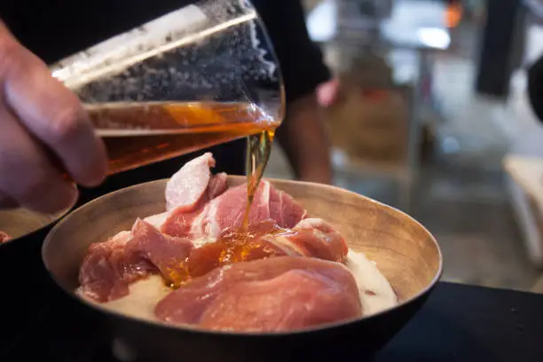 meat being marinated with craft beer
