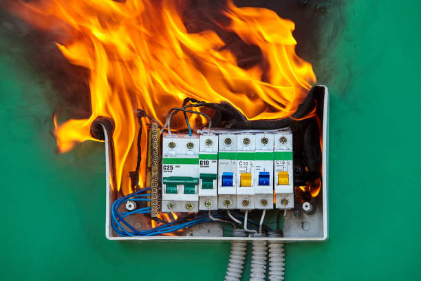 Problem with electrical wiring caused a fire. Damaged circuit breaker became the cause of electrical short circuit and caused the switchboard to ignite of fire. Bad electrical wiring systems caused fire inside electrical fuse box of home wiring. short length stock pictures, royalty-free photos & images