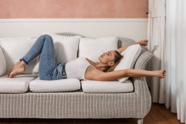 istock Businesswoman stretching arms on hotel sofa 1161020661