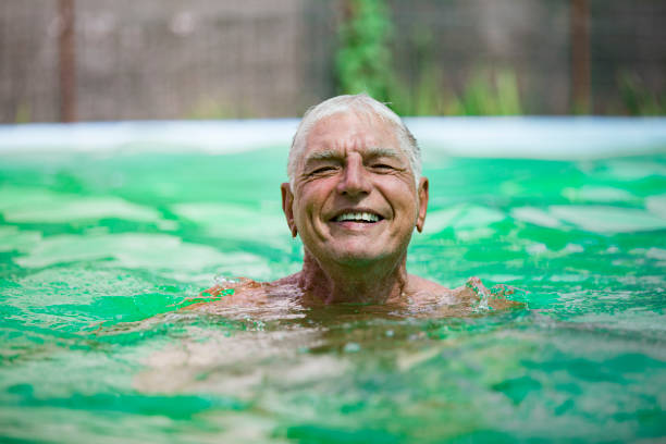 istock Smiling Senior Man Swimming and Relaxing in Pool 1161029184
