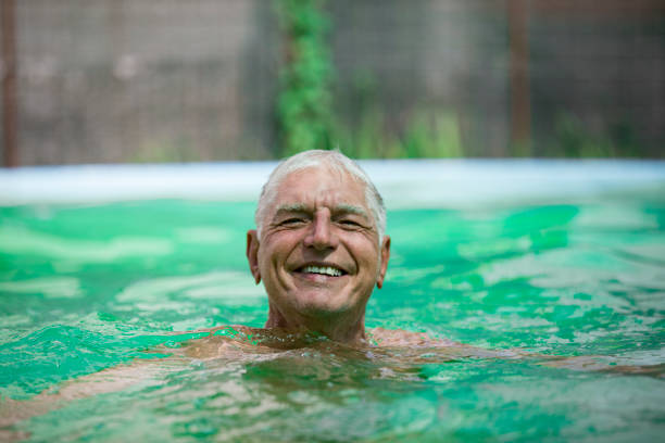 istock Smiling Senior Man Swimming and Relaxing in Pool 1161029186