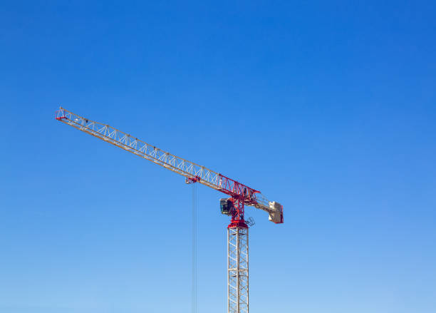 istock Industrial construction crane or column-jib crane with cabin works  on the construction site and blue sky is a background. Space for your text. 1161030799