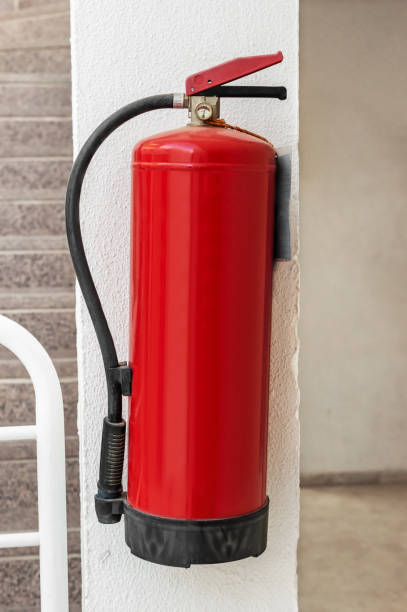 istock Extinguisher on the wall of building. 1161033554