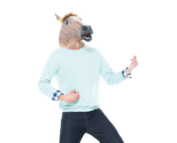 istock Man with horse mask doing air guitar 1161035237