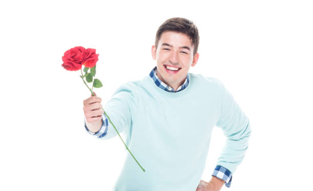 istock Attractive man kneeing on floor and holding a red rose 1161035242