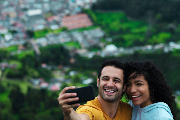 istock Couple embraced on a balcony after trekking, taking a selfie 1161039023