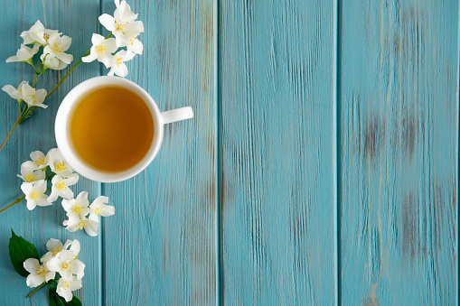 Jasmine tea on a blue wooden background. Relaxing jasmine tea. Aromatic teas for relaxation