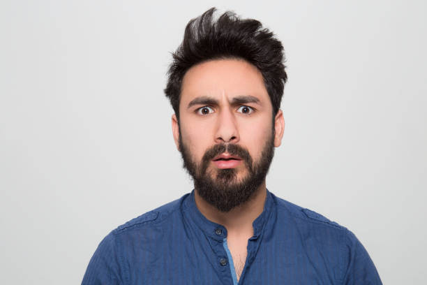 istock Portrait of shocked young man over grey background 1161042146