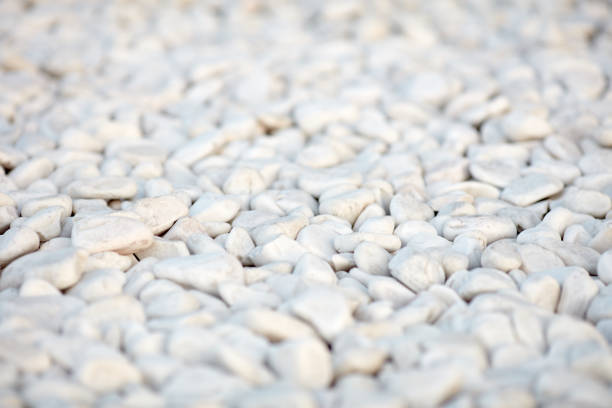 Naturally polished white rock pebbles background. white stones in design
