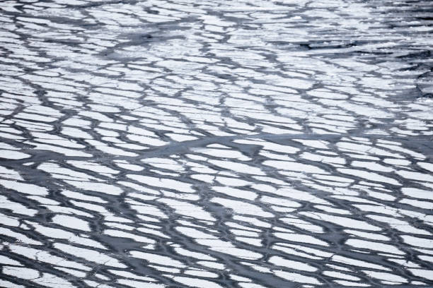 istock ice on the pond. water freezing 1161046548