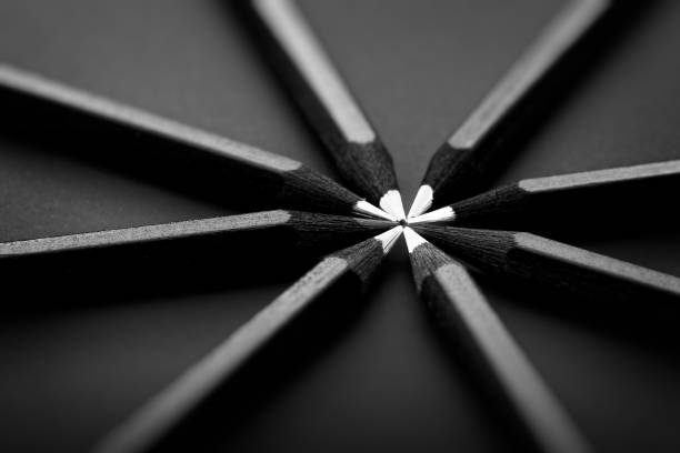White and black colored pencils. stylish business concept, on black background