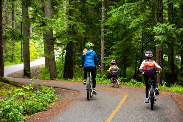 istock Mother and daughters cycling to school 1161050048