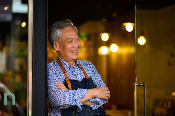 Happy owner with arms crossed at restaurant