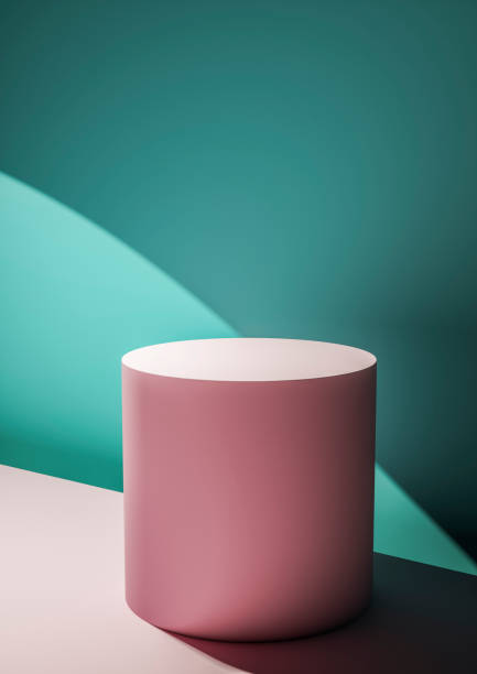 istock Pink circular display plinth against a green wall 1161051934