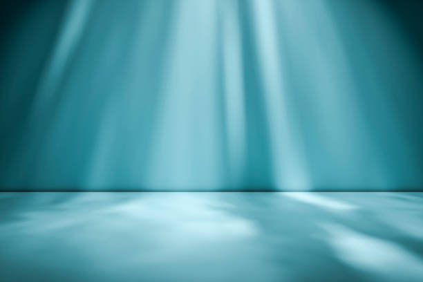 istock Beams of sunlight on a blue green background 1161052005