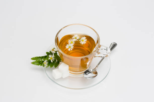 Cup of camomile tea with camomile flowers