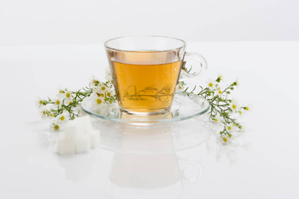 Tea glass with handle and red tea against black background - Bottom shot