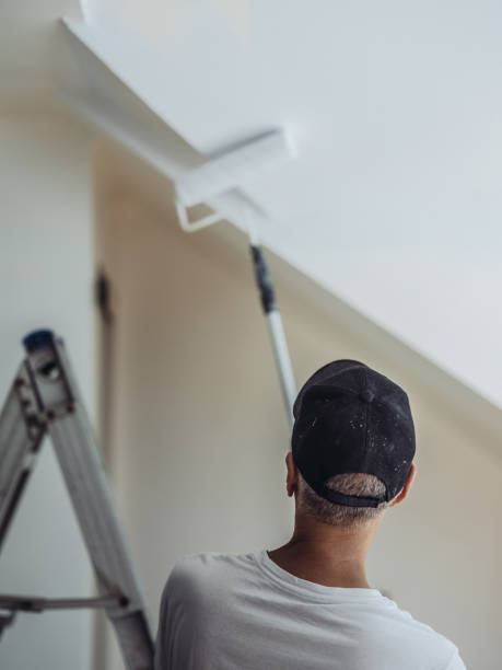 Senior man painting apartment interior