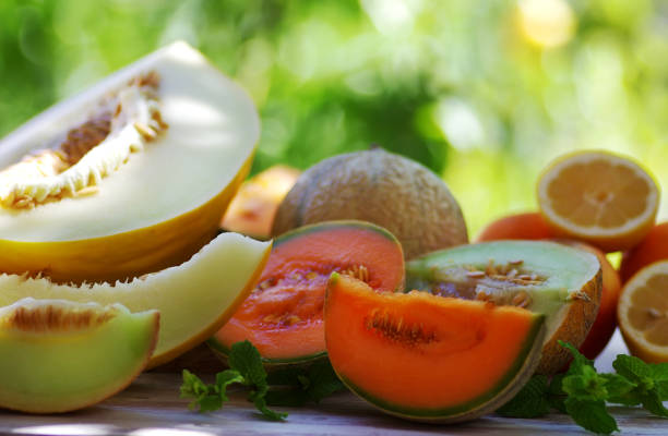 Cantaloupe melon slices on wooden table