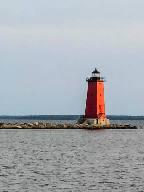 istock Red lighthouse by lake in Michigan 1161063798