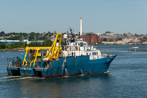 New Bedford, Massachusetts, USA - July 9, 2019: Survey vessel Shearwater, hailing port New York, New York, on Acushnet River in New Bedford