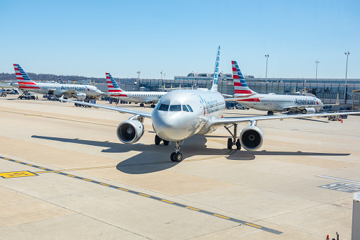 Washington, DC, United States - March 26, 2019: Ronald Reagan Washington National Airport view,  The airplanes of American Airlines are waiting for travelers on the Ronald Reagan Washington National Airport in Washington DC, USA.