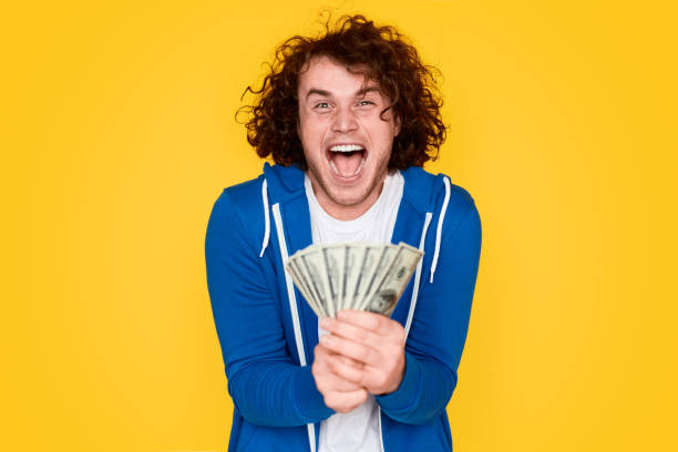 istock Lottery winner with money 1161070365