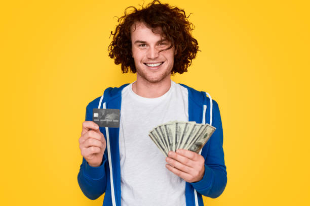 istock Smiling man with money and credit card 1161070372