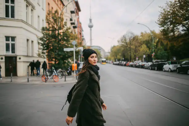 Portrait of a young woman wearing casual clothing, walking and shopping in Berlin, Prenzlauer Berg district.