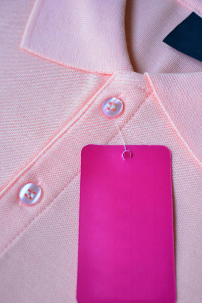 istock Light orange polo t-shirt and pink tag label. 1161076848