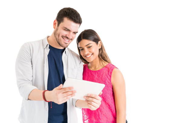 istock Latin Couple Sharing Watching Video In Studio 1161080516